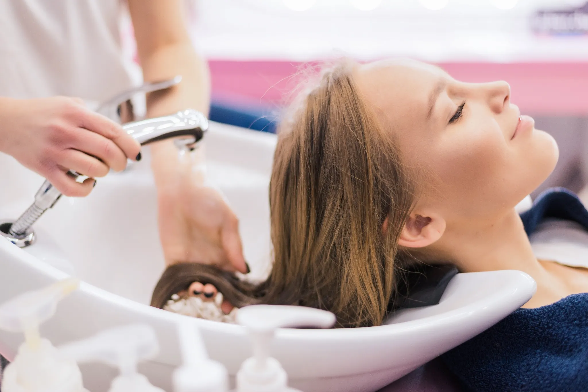 A woman brushing her hair, see a dermatologist for a healthy scalp